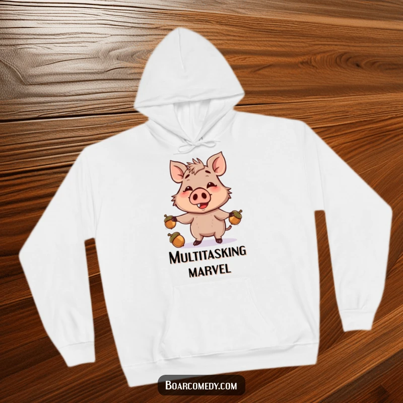 Funny hoodie featuring a smiling brown boar character expertly juggling acorns with its snout, promising comfort and chuckles.