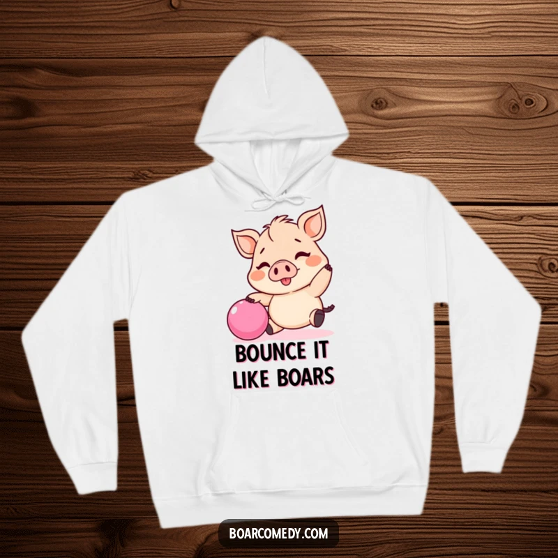 Funny Kawaii boar hoodie, featuring a joyful tiny boar in the middle of bouncing a bright pink ball.