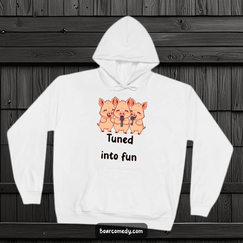 Funny group of three cute boars giggling and holding miniature microphones, a cozy hoodie perfect for comedy fans.